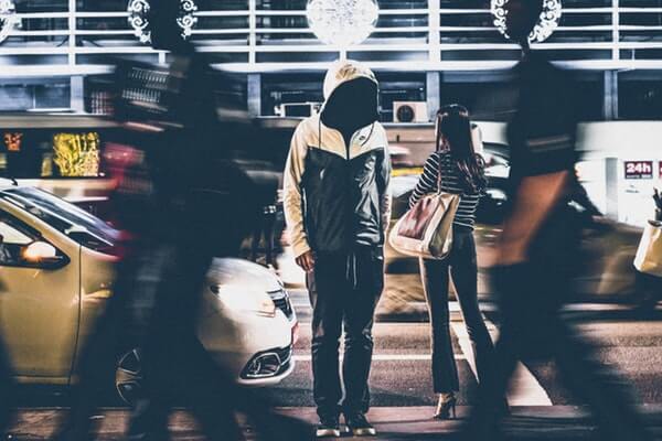 Man standing still in crowded street