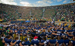 Sept. 21, 2013; The football team sings the Alma Mater with the student section after the win over Michigan State. Photo by Matt Cashore