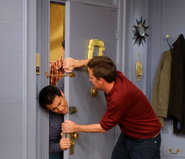 Chandler locks Ross and Joey out of the apartment in Friends.