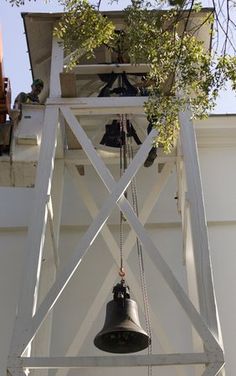 University of Georgia sheet metal mechanic Mark Collinsworth, left, and maintenance mechanic Robby McCurley, right and hidden, of the Physical Plant work on hoisting the bell on the Chapel on North Campus at the University of Georgia on Thursday, November 1, 2007. The yoke holing the bell was broken on Saturday, October 27th as students rang the bell after the Bulldogs win over the Florida Gators. Photo taken 11/1/2007. (University of Georgia/ University of Georgia, Andrew Davis Tucker).