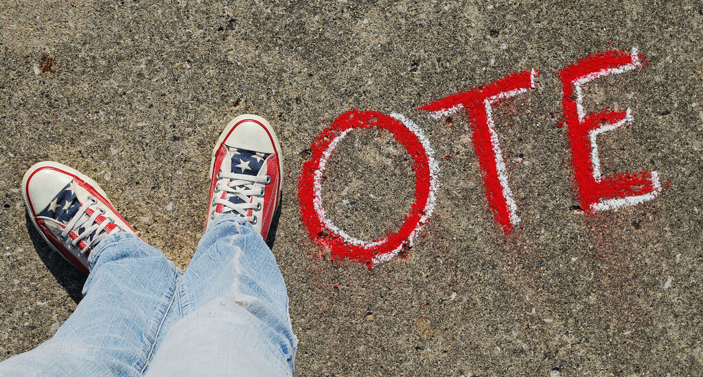 converse sneakers spell out vote with chalk