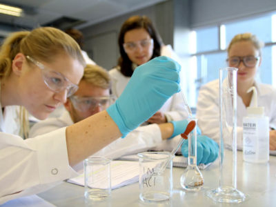 Students experiment in a chemistry lab