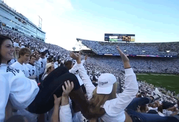Penn State students crowd surf at football game