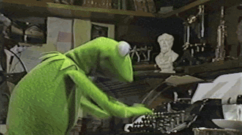 Kermit the Frog types frantically on a typewriter at his job