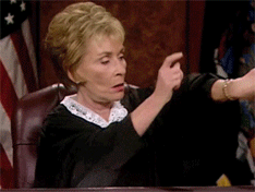 Judge Judy taps her watch impatiently before emphatically banging on the table.