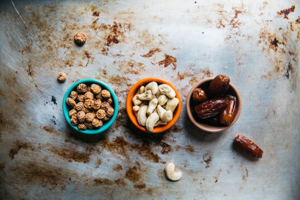 Peanuts, walnuts and almonds in separate bowls