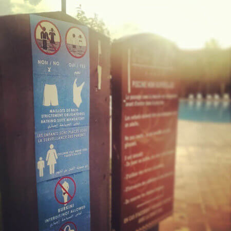 A sign reads "burkini not allowed." 
