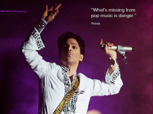 Prince raises his arms mid-dance on stage, his quote 