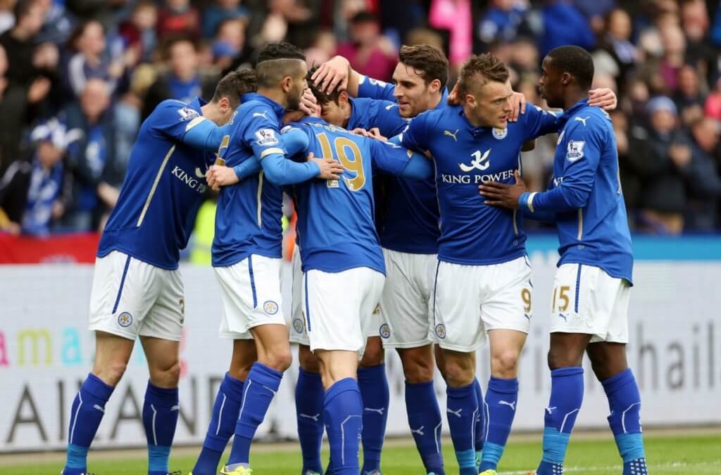 the Leicester City soccer team gathers on the field