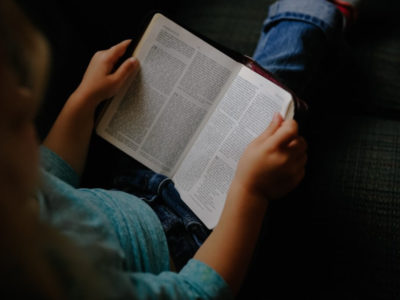 A girl reading a book by herself