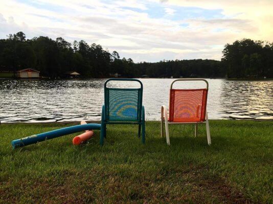 Two lawn chairs overlook the shore of Lake Warburg in Gainesville. 