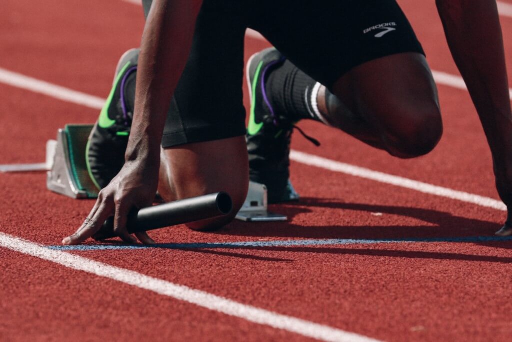 A man prepares to begin his track race.