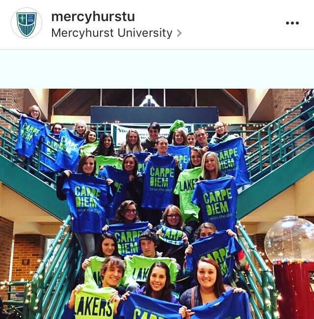 Mercyhurst students hold up school spirit shirts