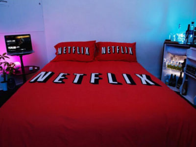 Bed with Netflix and chill sheets and pillows