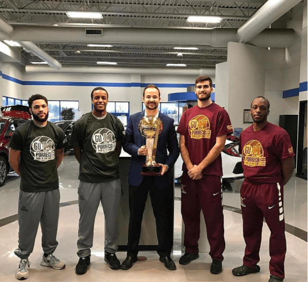 Mercyhurst athletes with a trophy 