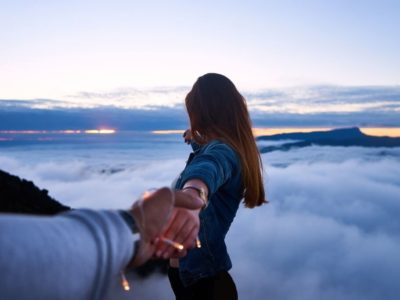 long-distance relationship couple holding hands looking at clouds