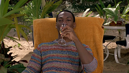 This picture shows Eddie Murphy on vacation with a glass of wine in his hand.