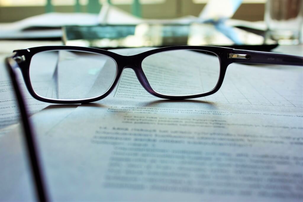 glasses on top of paper that shows your writing skills 