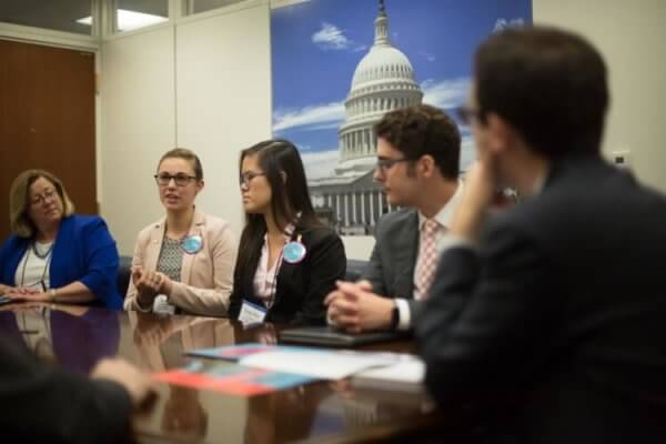 Students talking with congressmen in Washington, D.C. during the NAfME Hill Day. 