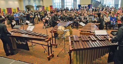 Musicians playing instruments in front of an audience for Texas Music Educators Association Clinic.