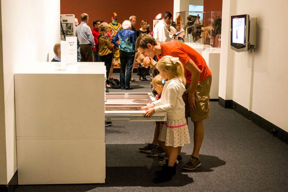 a man and two kids looking at art at the Harn Museum during an event in Gainesville 