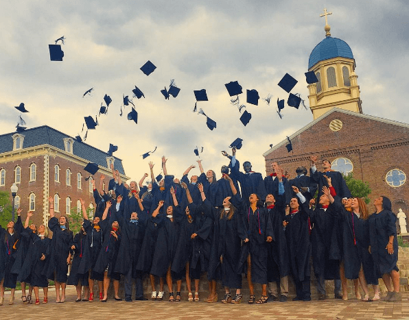 UD alumni throw their hats in the air.