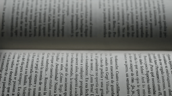 Reading a Book with Falling Words Gif
