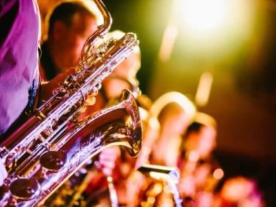 Florescent lighting with a strong purple focus on Saxaphone players.