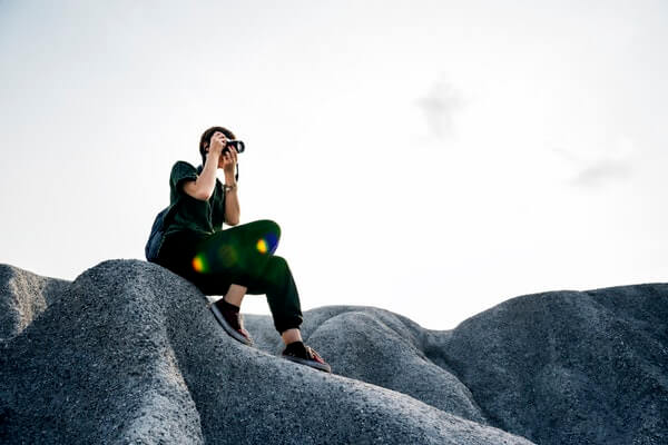 Person on rocks taking a photo