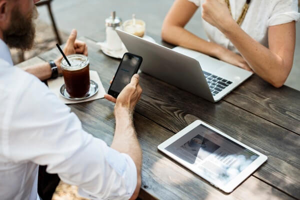 Man and woman conversing over a cup of coffee how to get started in the film industry