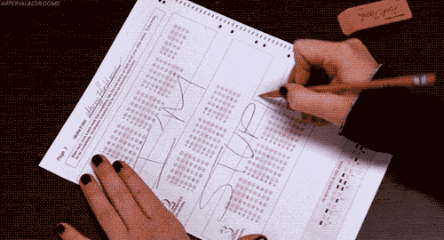 Student writing out "I'm stupid" across scantron