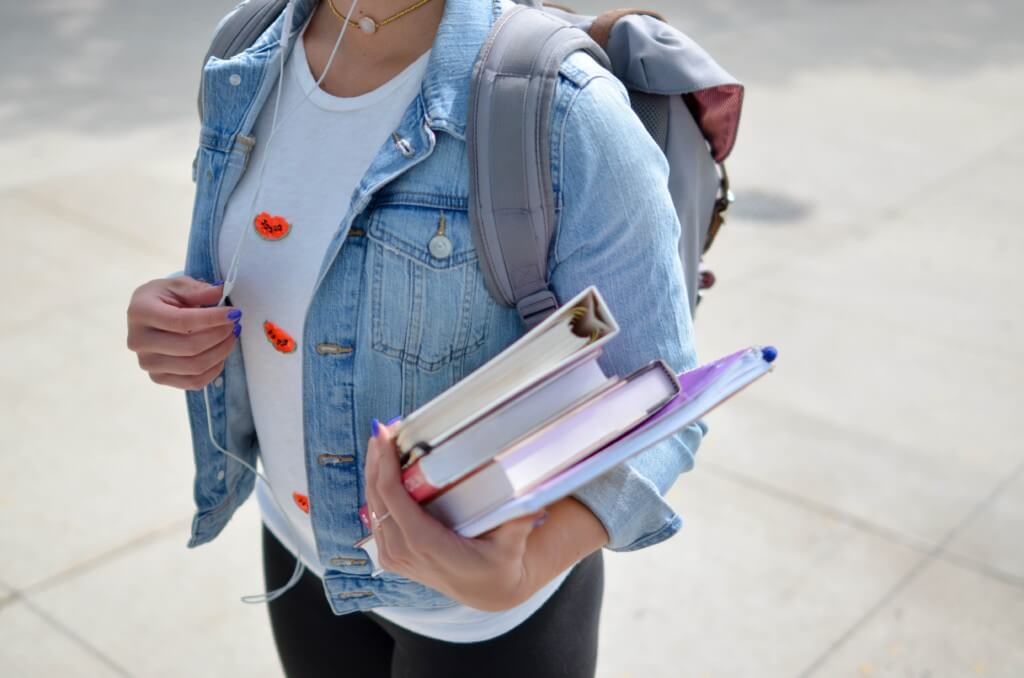 student carrying books 