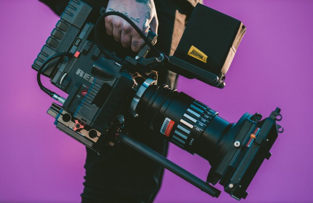 Man Holding Camera “Nuru means ‘a ray of light’ in Swahili. These are stories and perspectives that usually don’t get put in the light, things that we usually don’t see in the media,” said University of Iowa junior Dylan Goncalves. 