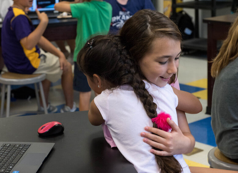 hugging student