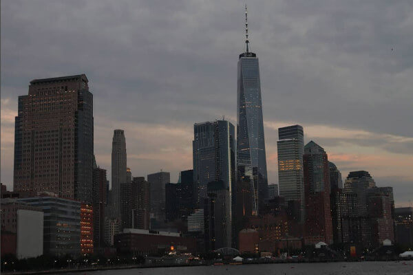 A picture of the One World Trade Center skyline at sunset.
