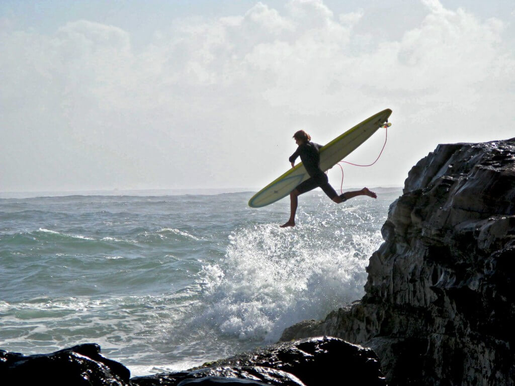 surfer diving into ocean