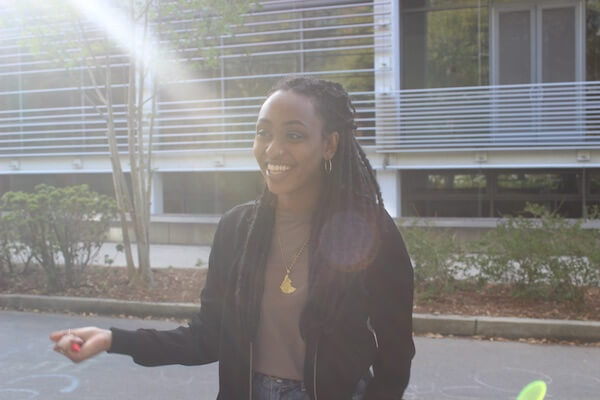 Tulane student in front of student center in a black jacket