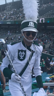 Marching band member in a tulane uniform