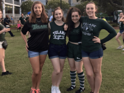 four girls arm in arm wearing Tulane gear