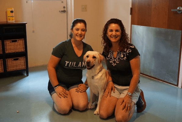 Tulane student with her mother and a service dog in training