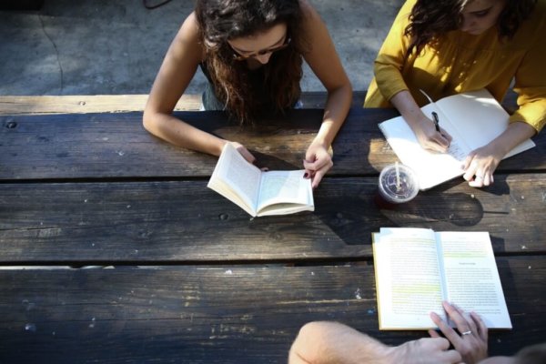 girls sitting with books