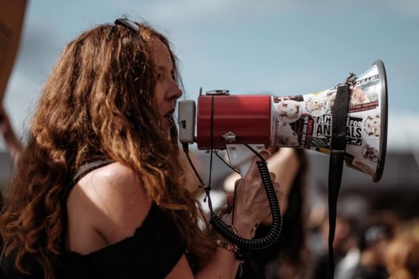 woman speaking into loudspeaker