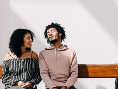 how to ask a shy guy out- man and woman on bench talking.