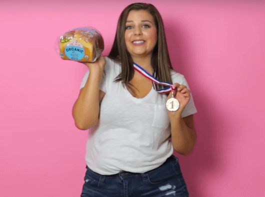 woman holding bread and a gold medal halloween costume