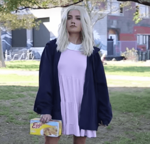 woman dressed as eleven from Stranger Things in a field halloween costume