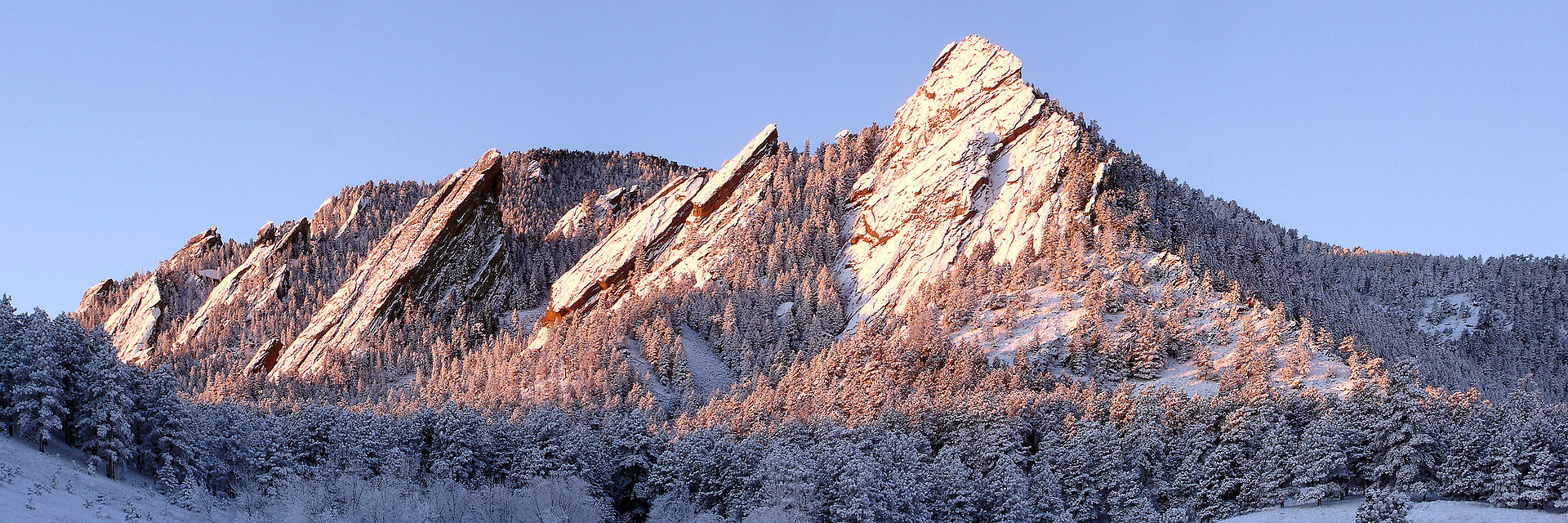 Mountain with sun shining best colleges for skiers boulder