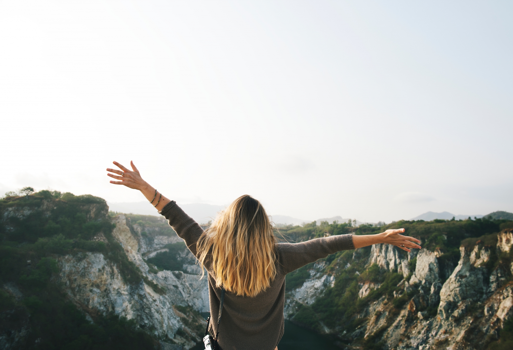 adult student hands open toward mountains