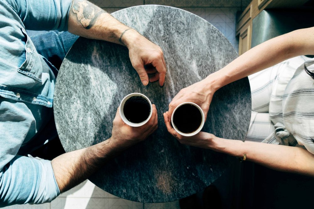 people having a conversation over coffee