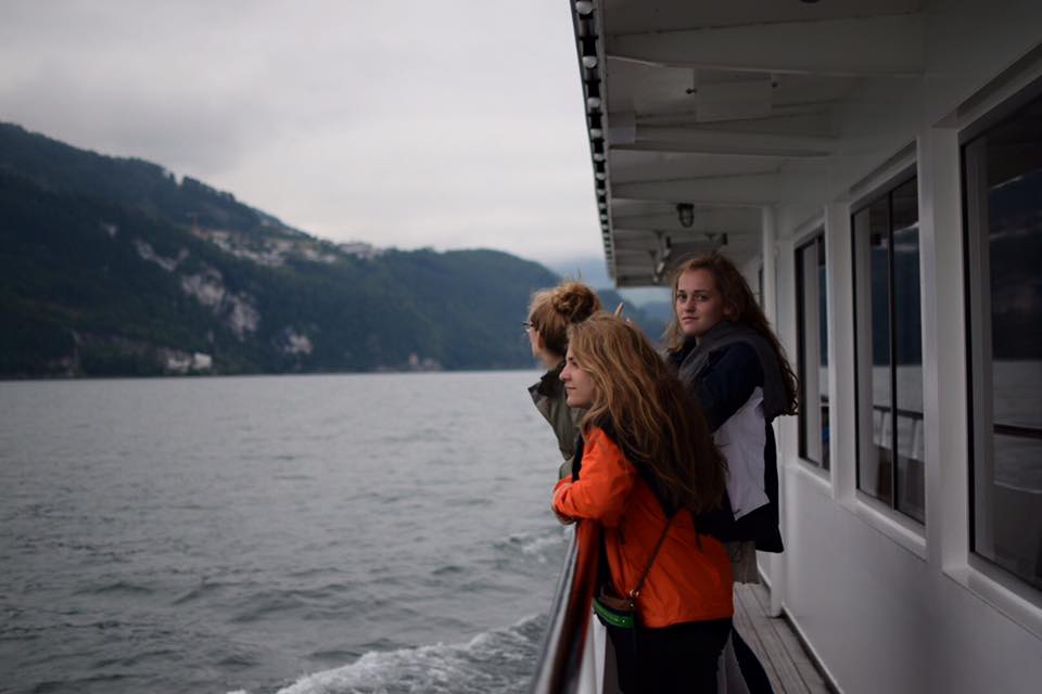 girls on ferry boat with mountains best places to visit in europe