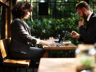 woman and man working on laptops interpersonal skills